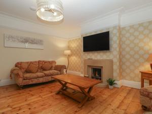 a living room with a couch and a fireplace at Greenlawns in Burnham on Sea