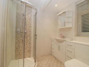 a bathroom with a shower and a sink at Greenlawns in Burnham on Sea