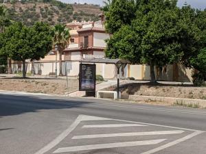 an empty street with a sign on the side of the road at Renovated apartment on beachside with pool in Nerja