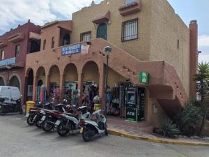 a group of motorcycles parked in front of a store at Renovated apartment on beachside with pool in Nerja
