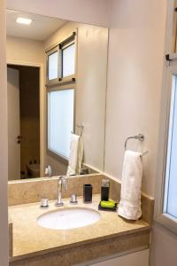a bathroom with a sink and a mirror at Departamento Tucuman in San Miguel de Tucumán +36 photos