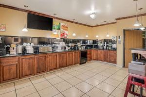 a large kitchen with wooden cabinets and appliances at Econo Lodge Lubbock I-27 in Lubbock