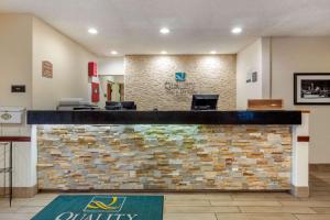 a lobby of a quality hotel with a stone wall at Quality Inn & Suites Lakewood - Denver Southwest in Lakewood