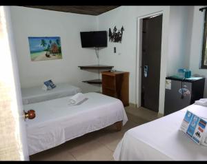 聖安德烈斯的住宿－Posada Doña Rosa，酒店客房设有两张床和电视。