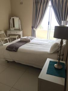 Katil atau katil-katil dalam bilik di Unit 62 Sealodge Umhlanga Beach