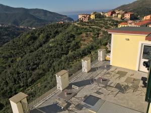 a balcony with chairs and a view of a mountain at Agriturismo SanCristoforo in Levanto