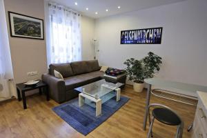 a living room with a couch and a table at SK Apartments - Liborius in Gelsenkirchen