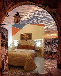 a bedroom with a bed with a view of a city at La Casa di Pina in Modica