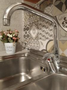 a sink with a faucet in a kitchen at La Casa di Pina in Modica