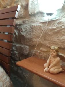 a baby sitting on a bench under a lamp at La Casa di Pina in Modica