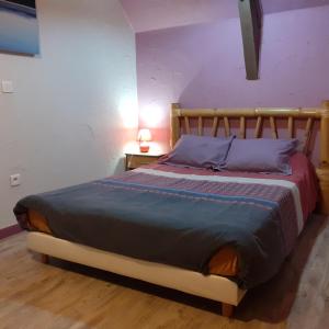 a bedroom with a large bed with a wooden headboard at chez vous chez nous in Antigny +42 photos