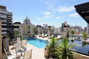 a rooftop patio with a swimming pool on a building at Windsor Hotel in Córdoba