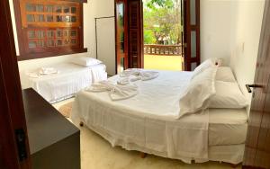 a bedroom with two beds with white sheets at Loft Jeri in Jericoacoara
