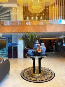 a table with vases on it in a lobby at Lady Diana Hotel in Istanbul