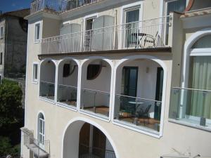 a building with balconies and tables on the balcony at Hotel Bonadies in Ravello