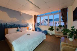 a bedroom with a bed with a mountain mural on the wall at Moc Thach Hostel Dalat in Da Lat