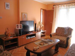 a living room with a tv and a coffee table at Apartment Stana in Petrovac na Moru