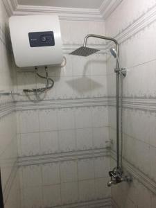 a bathroom with a shower with a shower head at Elstine’s in Lagos
