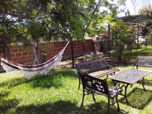 two chairs and a table and a hammock in a yard at Irundy Apartments in Federación