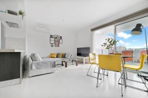 a living room with a table and yellow chairs at Glabur Stays - The Fabulous 2 BDR - Nicosia City, Free Parking & Wifi, Welcomes You!!! in Nicosia