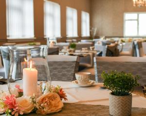 a table with a candle and flowers on it at Conwy Valley Hotel in Conwy