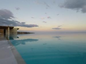 a view of the ocean from a hotel swimming pool at Portela Apartments Kastri in Keratokampos