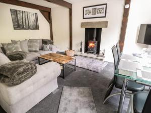 a living room with a couch and a fireplace at Little Barn in Keighley