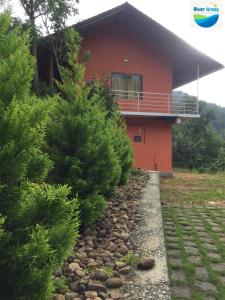 a house with a gravel path in front of a building at River Arena Holidays in Vagamon