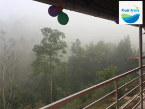 a view of the misty forest from a train station at River Arena Holidays in Vagamon