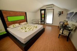 a bedroom with a large bed with flowers on it at Drinsko jutro in Bijeljina +21 photos