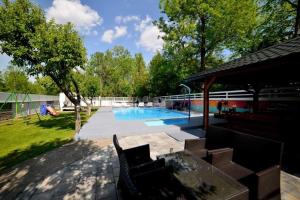a backyard with a swimming pool and a playground at Drinsko jutro in Bijeljina