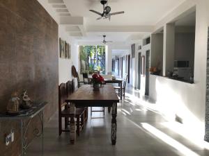 a dining room with a table and chairs at lux pousada in Porto Seguro