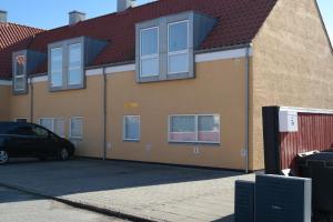 a house with a car parked in front of it at Skagen New City Apartments 1D in Skagen