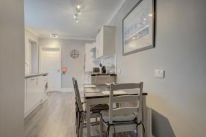 a kitchen and dining room with a table and chairs at Sunderland Self-Catering 1 -Chester Cottage in Sunderland