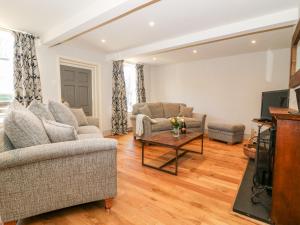 a living room with two couches and a tv at The Old Post Office in York