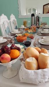 a table topped with plates and bowls of food at La Maison Brasiliana B&B in Foz do Iguaçu