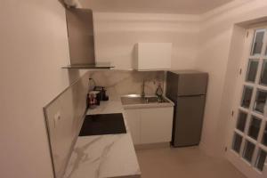 a small kitchen with a sink and a refrigerator at Casa Vacanze Laura1 in Lecce