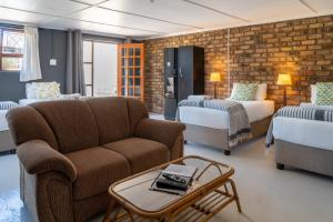 a living room with a couch and a bed at Selborne Bed and Breakfast in East London