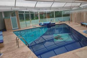 a large swimming pool in a building at San Marino in San Francisco Tlalnepantla