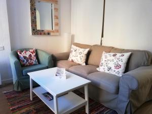 sala de estar con sofá y mesa en Apartamentos Deluxe con parking y wifi by SURYNIEVE, en Sierra Nevada
