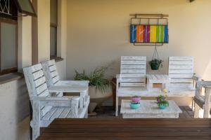 two chairs and a table on a patio at Selborne Bed and Breakfast in East London