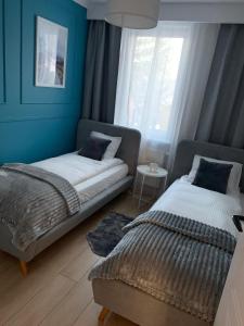 Posteľ alebo postele v izbe v ubytovaní Apartament "OldMountain" Olimpijska 1C 1 + 25 fotografií