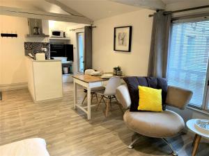 a kitchen and living room with a table and chairs at La Chantrerie in Cahors