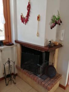 a living room with a brick fireplace with a fire place at BEST HOUSE CAMPO DI GIOVE in Campo di Giove