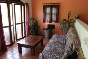 a living room with a couch and a table at La Posada Pacifica in Puerto Vallarta