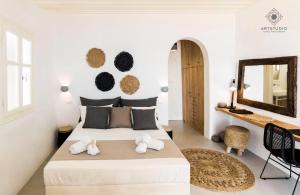 a bedroom with a large bed with a mirror on the wall at Astarte Luxury Apartments in Artemonas