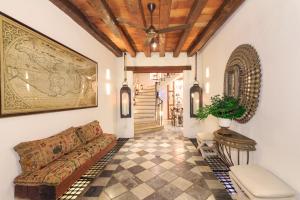 a living room with a couch and a ceiling at Hotel Boutique Casa del Coliseo in Cartagena de Indias