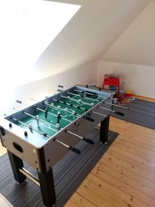 a ping pong table in the middle of a room at Apartman Glacier in Tatranska Strba