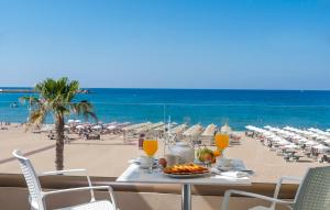 a table set up for a meal at a beach at Ilios Beach Hotel Apartments ADULTS ONLY in Rethymno