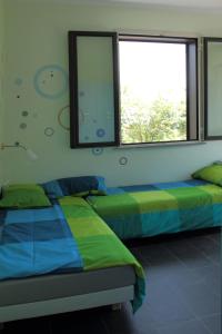 Llit o llits en una habitació de Etna Holiday Home